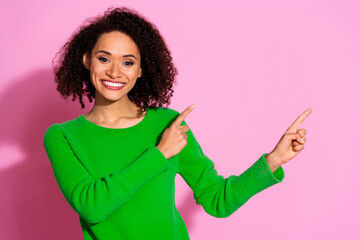 Sticker - Photo of charming cheerful cute woman wear green stylish clothes demonstrate banner empty space isolated on pink color background