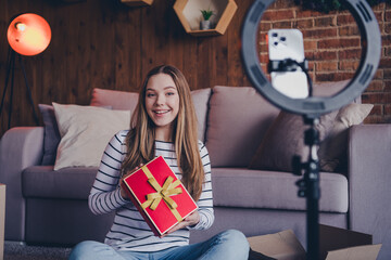 Poster - Portrait of nice young girl present tripod holder smart phone record video loft interior flat indoors