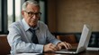 © Kasper - Older Businessman Using Laptop and Document