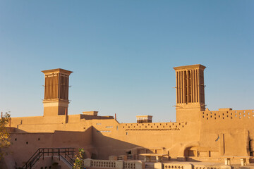 Twin antique windcatchers constructed with adobes representing Persian ancient architecture in Yazd, Iran. 