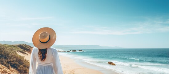 Poster - Woman in a Hat on a Sandy Beach