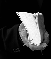 black man praying to god with crucifix and hands together Caribbean man praying on black background with people stock photos stock image	