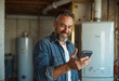 © Mattie - Handsome mature home owner in basement using smart phone to check on HVAC, electrical, plumbing. Technology technician in the service industry, quote, testimonial, blue collar worker