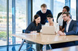 © peopleimages.com - Group, serious and laptop for review, office and discussion with men, brainstorming or thinking. Corporate, talking and feedback of media coordinator, women and ideas for campaign, project and people