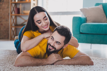 Wall Mural - Full body portrait of two young people lay carpet floor weekend pastime modern interior flat indoors