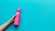 © Avr Di - An artist holds a pink spray bottle containing detergent for different surfaces in the kitchen.