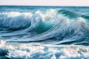 Ocean wave crashes on sandy shore, creating dramatic contrast. Deep blue wave with white foam creates motion, energy. Calm undisturbed water with visible objects. Slightly elevated angle provides