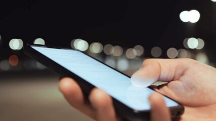 Poster - Close up shot of modern smartphone in male hands, guy scrolling device screen with social media in evening park