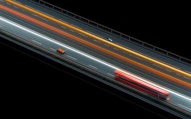 Cars and vehicles on the highway with motion blur and  light streams; highway and transportation; long exposure photography of vehicle lights; aerial view of the highway