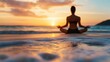 © Shisanupong - A woman meditating on the beach at sunset, sitting in a peaceful yoga pose with calm ocean waves in the background, promoting relaxation and mindfulness.