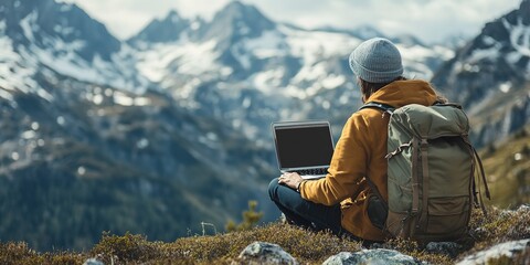 Poster - Freelancer with a laptop and a backpack working online in the mountains while hiking