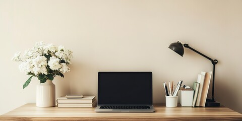 Poster - A minimalist workspace featuring a laptop with a black screen, a desk lamp, a vase with white flowers, books, and stationery on a wooden desk against a light beige wall.