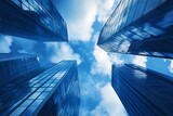 Low angle view of skyscrapers reaching up to the sky with clouds.