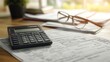 © Nawarit - Tax return preparation with documents and a calculator on a desk, organized style, close-up, sharp focus, bright lighting