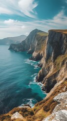 A panoramic view of a rugged coastline with dramatic cliffs and a vast expanse of deep blue water.