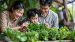 © Akharadat - Several Asian farmers working together in a hydroponics system on a vegetable farm. In a greenhouse garden, grandparents teach their grandchildren how to grow and care for organic lettuce vegetables.