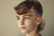 © miss irine - Young Caucasian boy with fresh mullet haircut. Male portrait with stylish coiffure. Attractive face with beautiful hair. Boy poses in lifestyle photo with fashionable style.