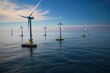 © miss irine - Wind turbines installed on the sea. Offshore wind farm with many turbines generating clean energy. Blue sea and sky background. Alternative energy source for sustainable electricity production.