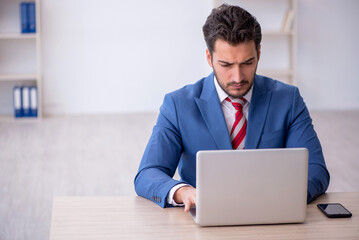 Poster - Young male employee working in the office