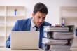 © Elnur - Young male employee and too much work in the office