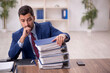 © Elnur - Young male employee and too much work in the office