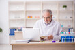 © Elnur - Old male chemist working at the lab