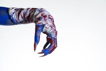 A blue witch hand with red nails, wrapped in a blood-stained bandage against a white background. This eerie, monstrous image evokes demonic, zombie, and ghostly vibes, perfect for Halloween horror.