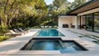 © Intach - Sleek rectangular pool with an integrated hot tub, surrounded by a minimalist patio with concrete pavers and lounge chairs.