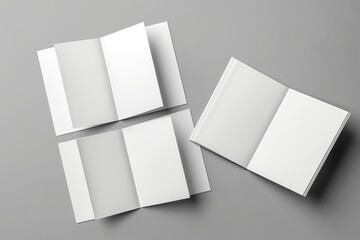 Blank brochures on grey background, open and closed, design mock-up. Top view of empty booklets, corporate style. No text, no logo, pro space for branding and design.