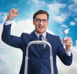 Wall Mural - Businessman with star award against sky