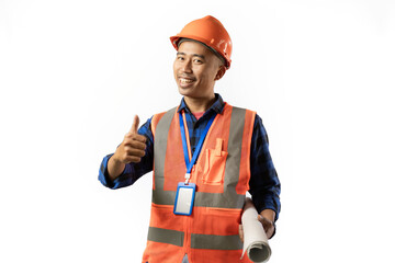 Asian male construction worker in full safety clothing stands looking at the camera confidently while carrying a roll of blueprints, industrial and construction concept, isolated white background.