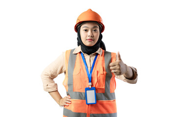 young Asian female construction worker in hijab stands looking at the camera while giving a thumbs up, industrial and construction concept, isolated white background.