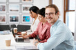 © Malambo/peopleimages.com - Business, man and portrait with happy at desk at copywriting agency for newsletter article or blog post. Coworking office, entrepreneur or writer with smile for creative process and story development