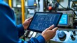 © pkproject - Worker Using Tablet to Monitor Production from Control Room