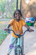 © Austockphoto - Out of focus Aboriginal girl smiling on bicycle