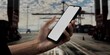© UnrealHands.com - Asian male using smartphone with a blank white screen. Cargo port, shipping containers, gantry cranes apps mockup. Vertical phone orientation