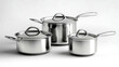 © Anoo - Three elegant stainless steel pots and pans showcase craftsmanship and shine, arranged for an artistic display that enhances any kitchen environment