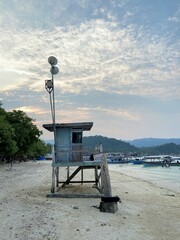 A lifeguard hut on the beach of Mutun Bandar Lampung, Indonesia in the afternoon with a cloudy sky in the background