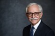 © pham - An older gentleman with a mustache and glasses is smiling warmly while dressed in a dark suit and spotted tie, creating a friendly atmosphere