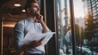 © pkproject - Thoughtful Entrepreneur Reviewing Business Plan at Glass Office Window