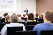 © leszekglasner - Rear view of the audience at a business conference meeting event listening to the speakers speech