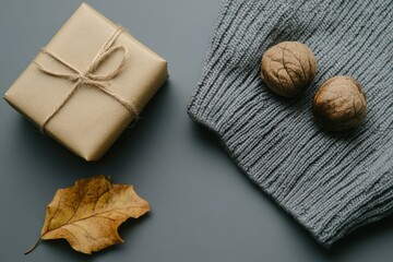 Wall Mural - Autumn gift box with walnuts yellow leaf on textured background