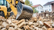 © Farhad - Excavator bucket picking up pile of bricks during demolition work