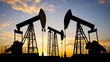 © Farhad - Silhouettes of oil derricks working at sunset