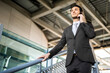 © Minerva Studio - Confident businessman making a phone call outdoors