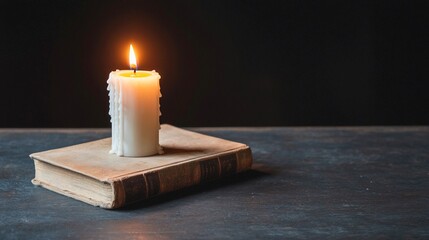 Burning Candle on Old Book  Dark Background  Still Life