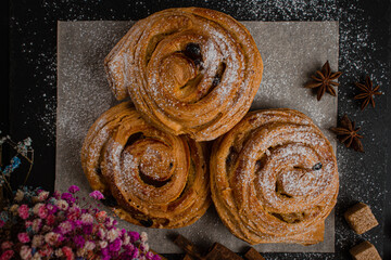 Wall Mural - Fresh baked goods on a black background. Sweet buns