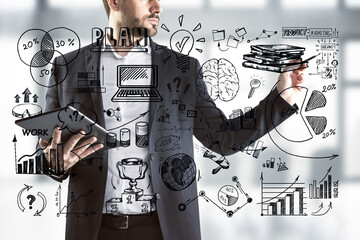 Aufkleber - businessman drawing business plan sketches on glass wall with a tablet in hand.