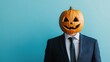 © Minerva Studio - Businessman wearing a jack-o'-lantern on halloween