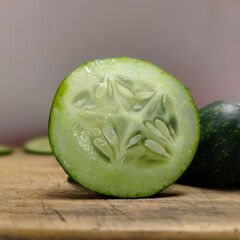 close up of cucumber slices on a wooden cutting board